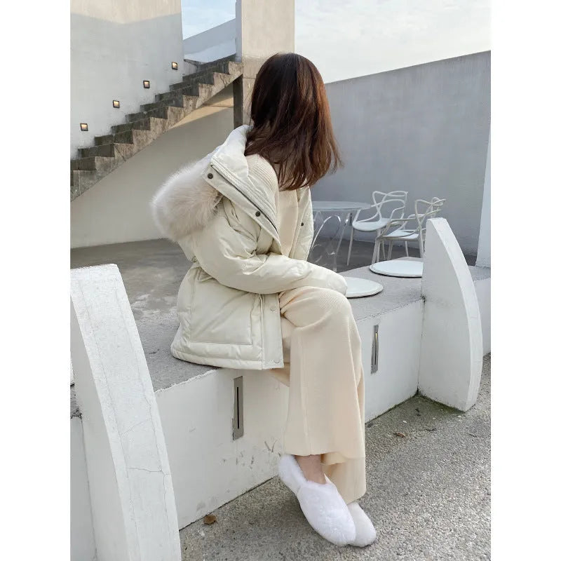 Women's cream white high-waisted wide-leg knitted trousers with a straight leg and drooping hem.