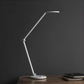 ProLED smart folding desk lamp with adjustable arm and LED light panel on a wooden desk.