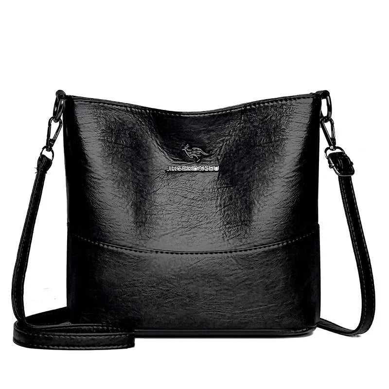 Women's soft leather bucket shoulder bag in solid colour with sewing line details and organisational pockets