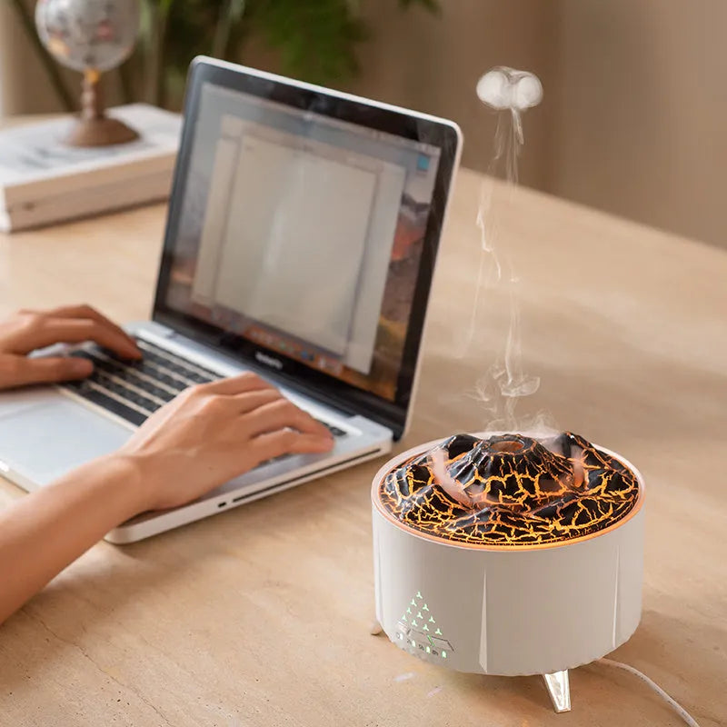White flame aroma diffuser with Bluetooth speaker and remote control on a table