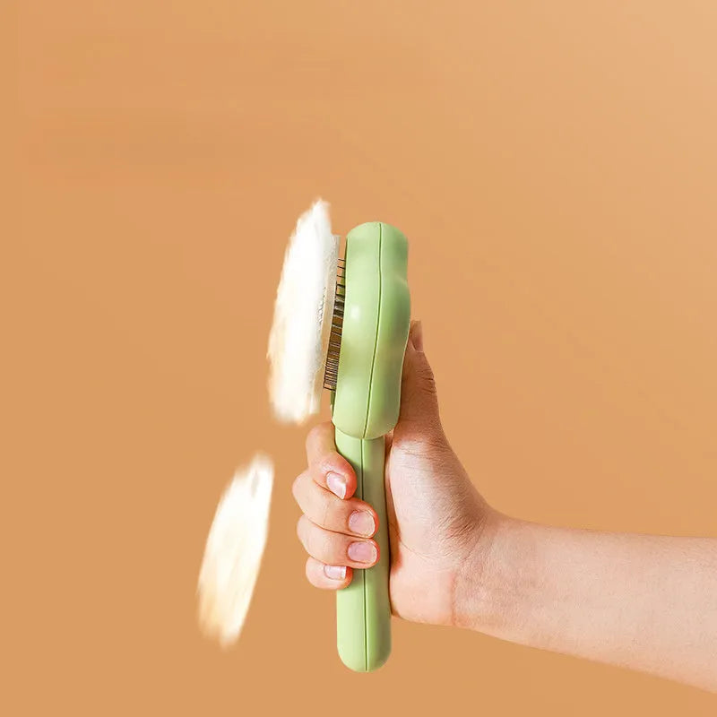 Green self-cleaning cat grooming comb with stainless steel needles and wand handle