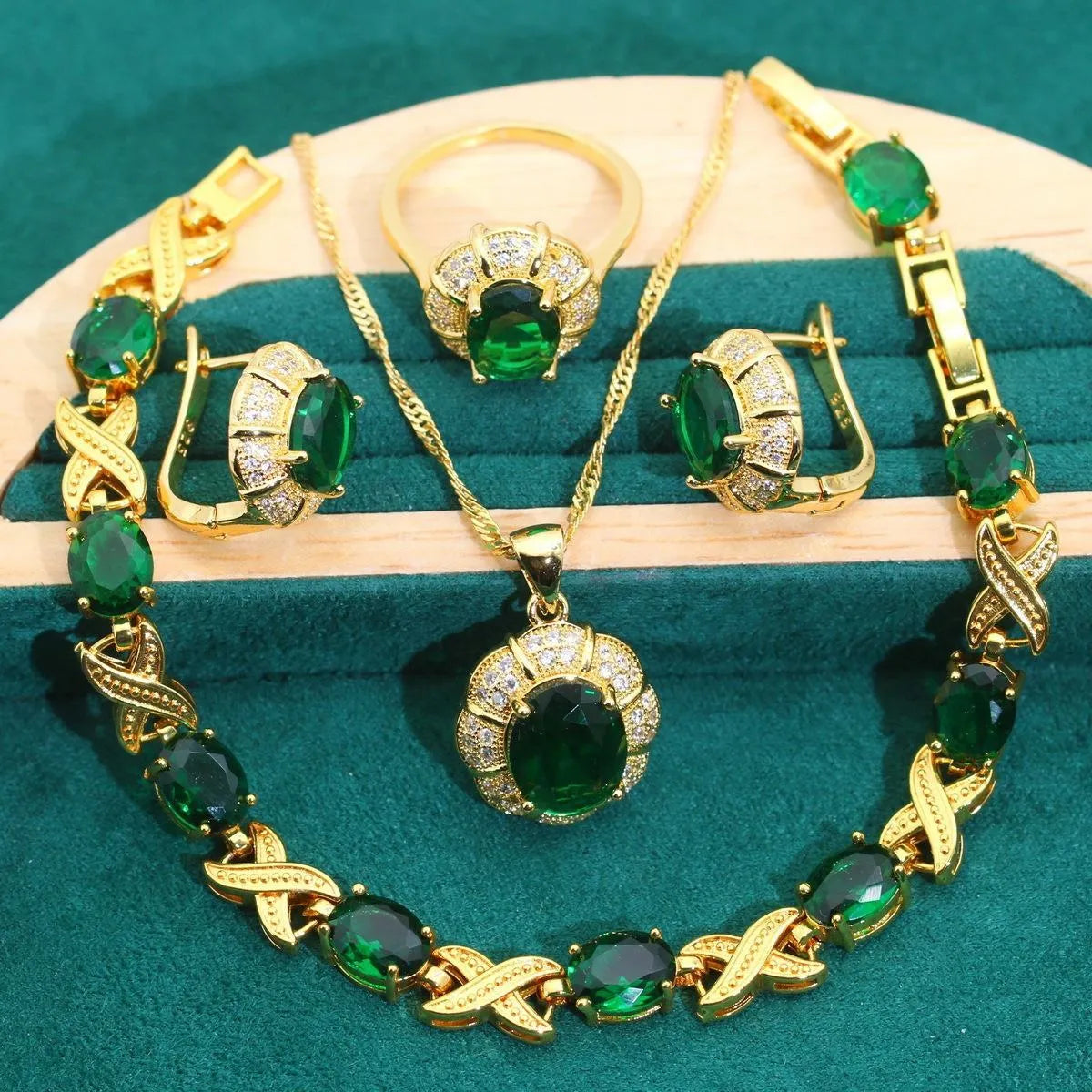 18k gold-plated necklace, bracelet, earrings, and ring set with blue cubic zirconia stones.