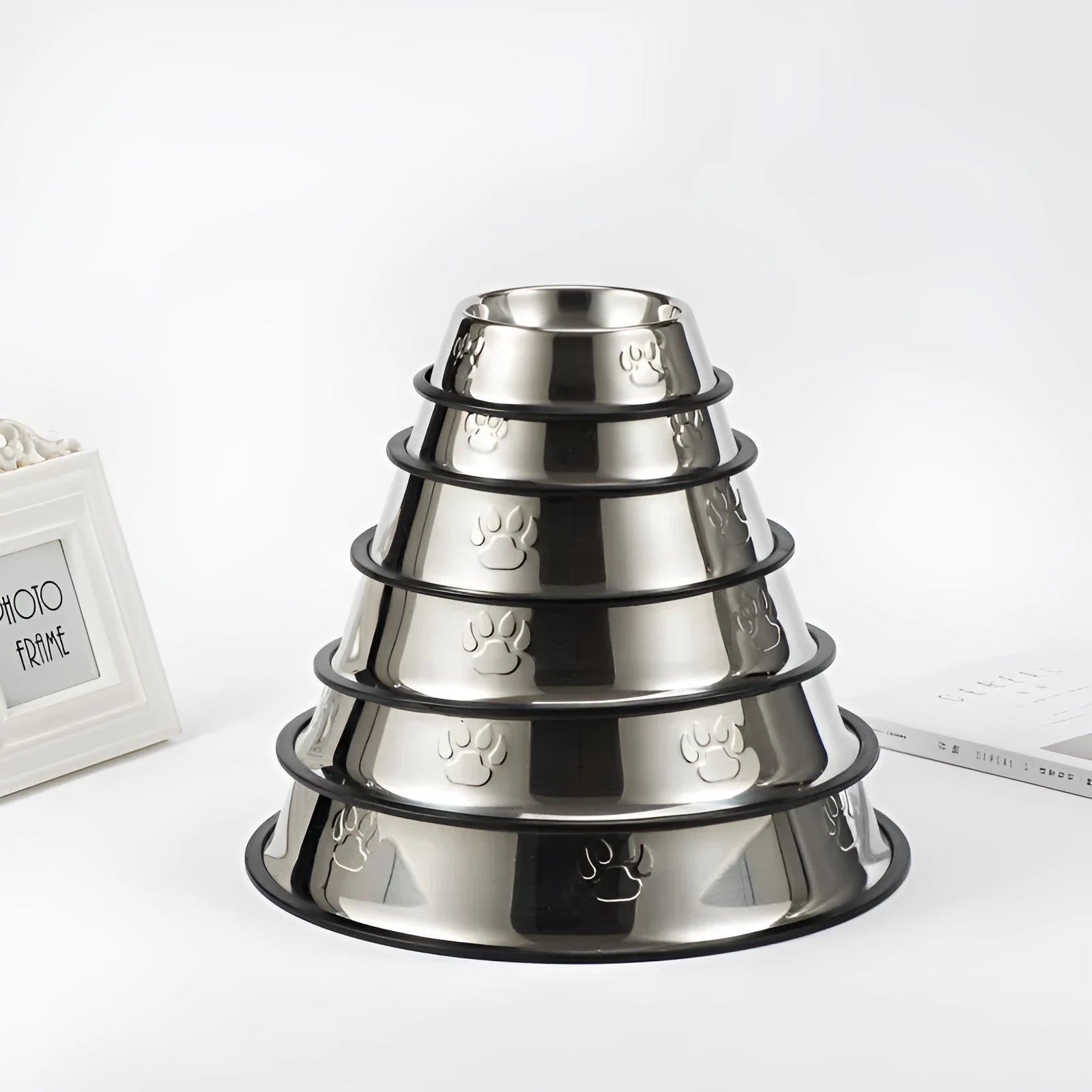 Stainless steel dog bowl with footprint pattern, available in sizes from 15cm to 34cm diameter