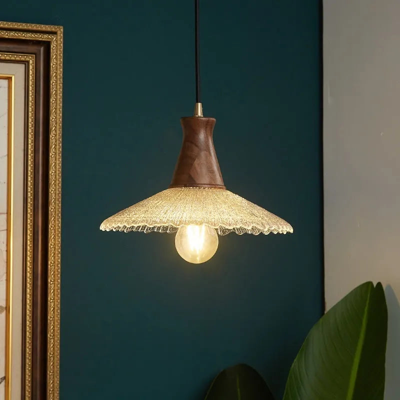 Brass-toned wood and glass chandelier with a retro design for ceiling mounting.