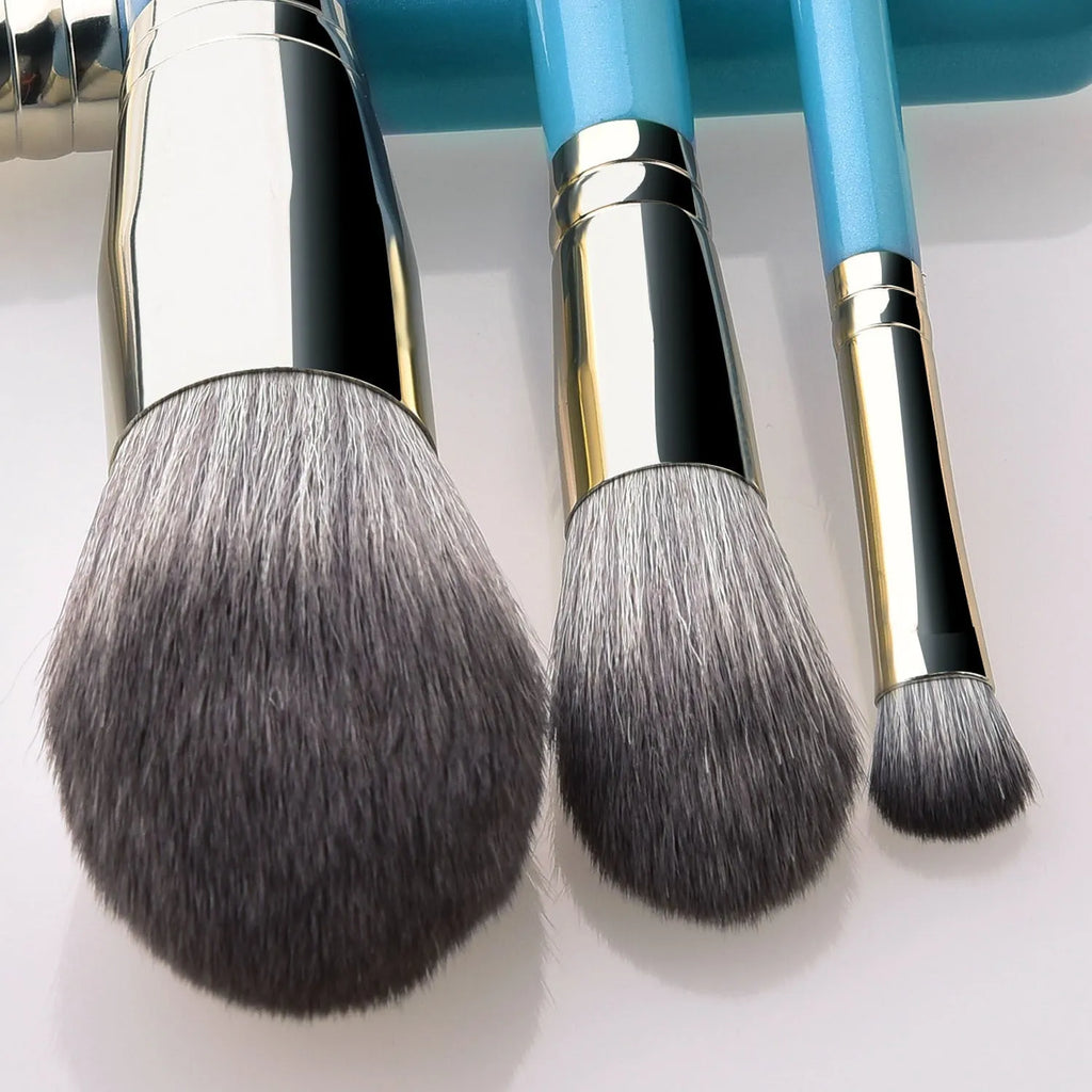 Blue 13-piece synthetic hair makeup brush set with wooden handles and aluminum ferrules on a clean surface