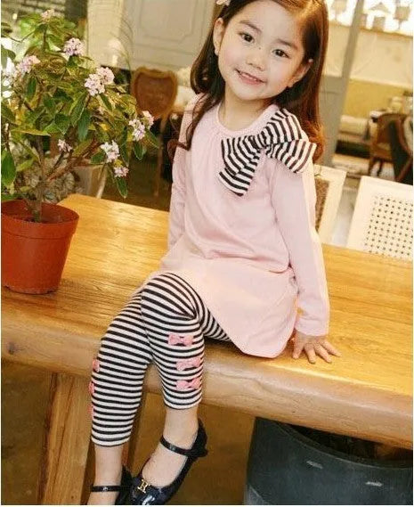Pink cotton clothing set for girls on a hanger, showing short sleeves.