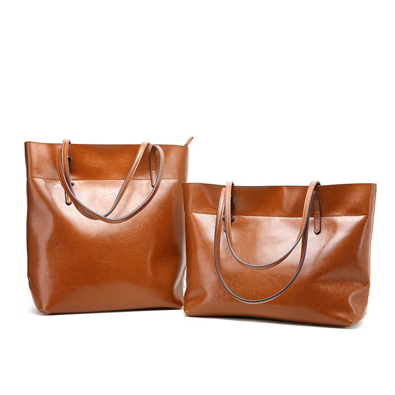 Brown waxed cowhide leather crossbody handbag showing front view with two compartments.