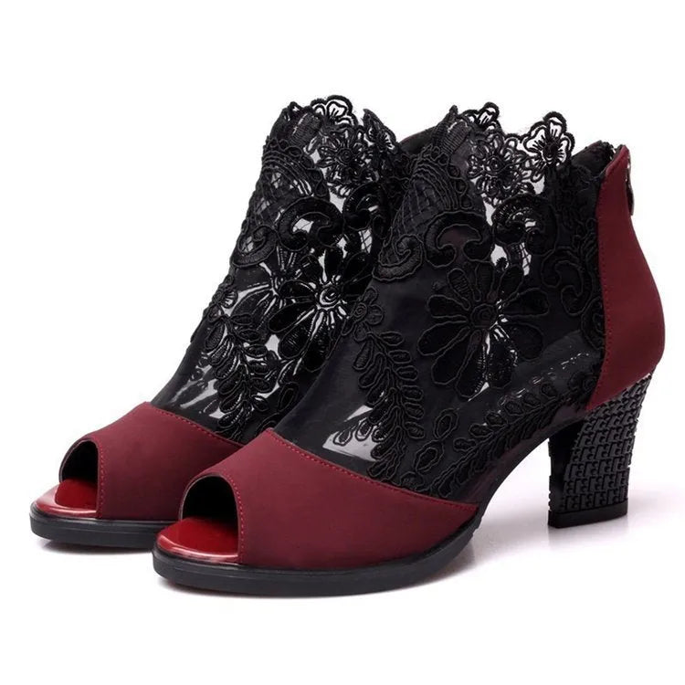 Women's black lace gladiator sandals with square heels and floral patterns, showing zip closure and peep toe design