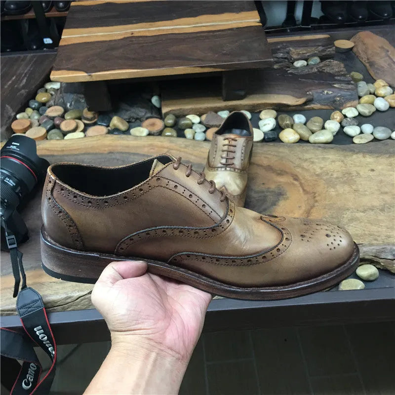 Men's light brown leather lace-up shoes with hand-distressed carving detail on the upper and a round toe.