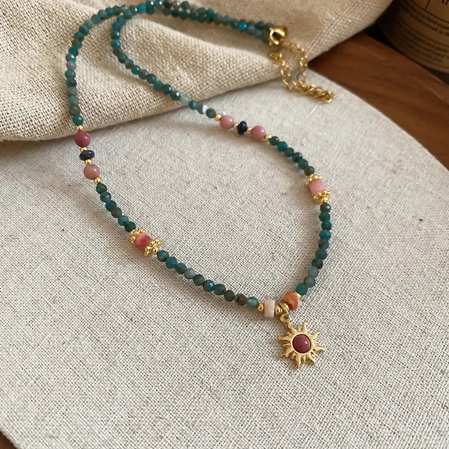 Freshwater pearl necklace with blue sun stone pendant on an adjustable clavicle chain.