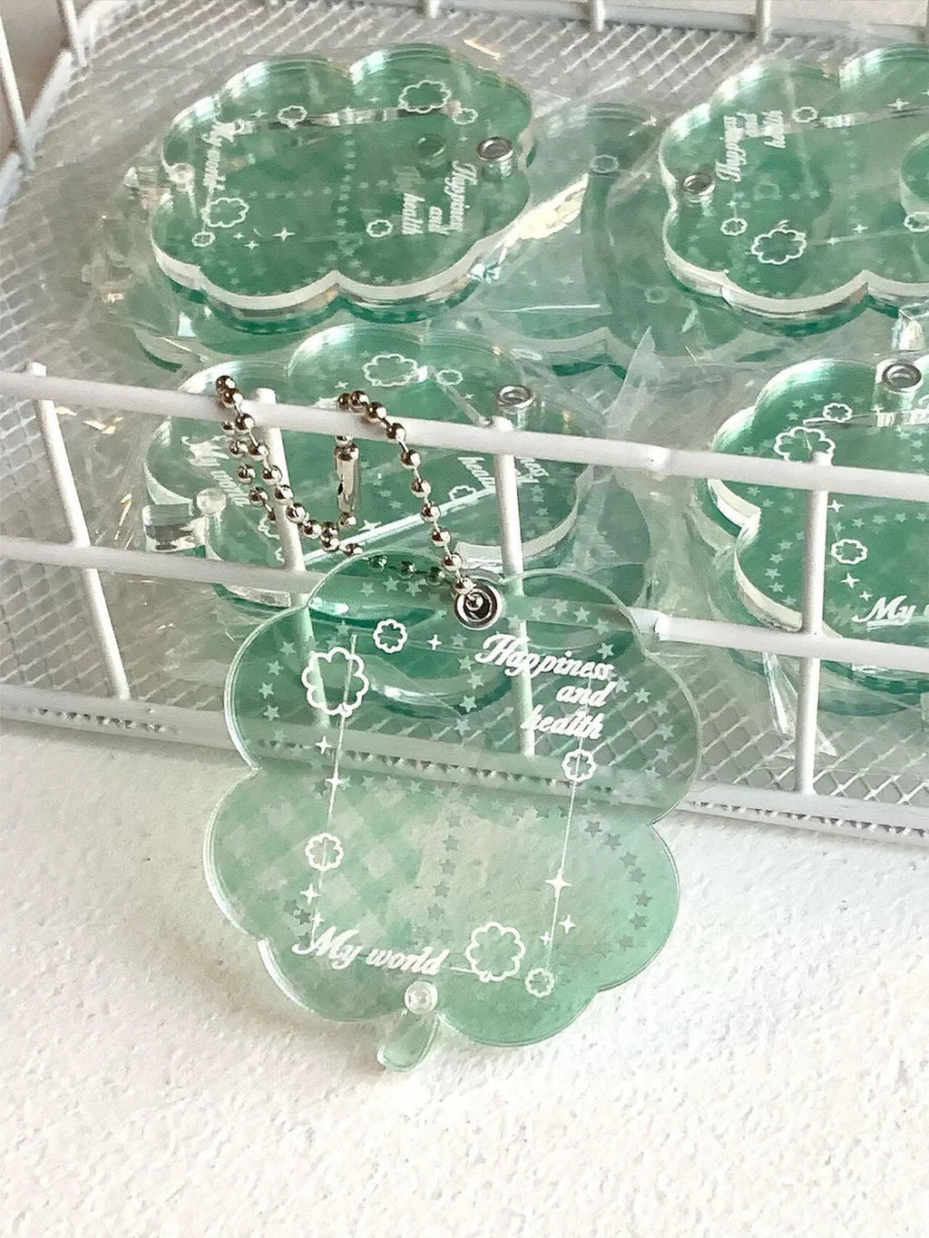 Acrylic four-leaf clover charm pendant keychain in blue, green, and mint colour options