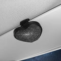 Black diamond-encrusted PU leather clip holding sunglasses and a ticket on a car sun visor.