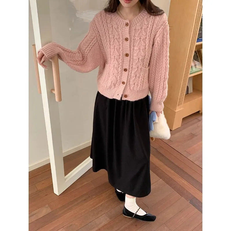 Solid colour thick needle twisted texture knitted cardigan in beige, short length, on model