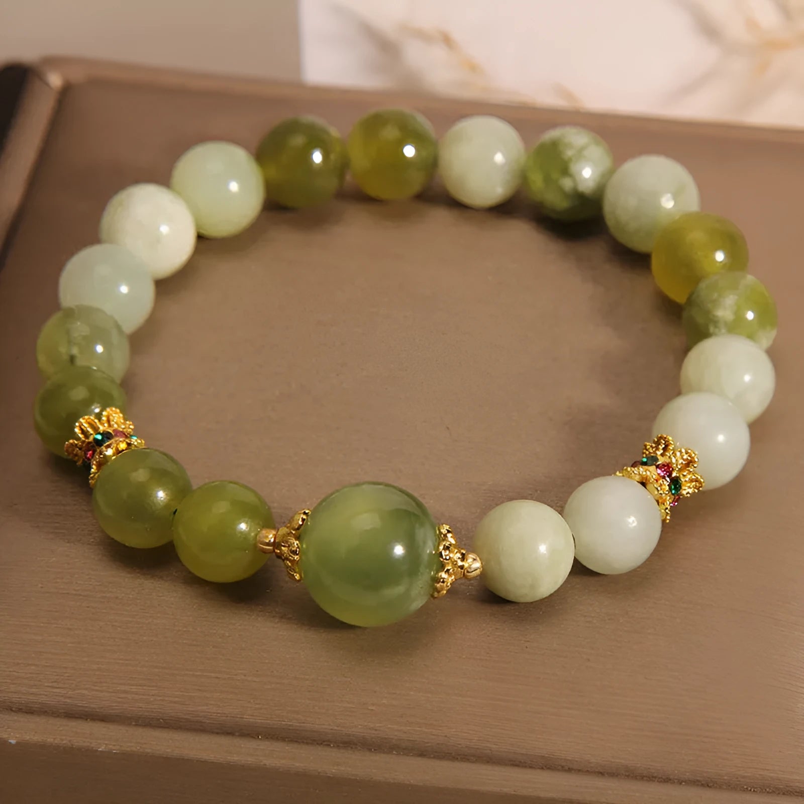 Xiuyan jade green mori-style women's bracelet with original design on a white background.
