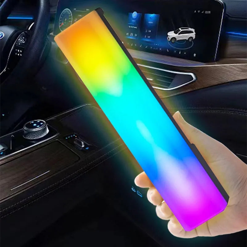 A tall, colourful RGB table lamp with a white or black shell reacting to sound on a desk.