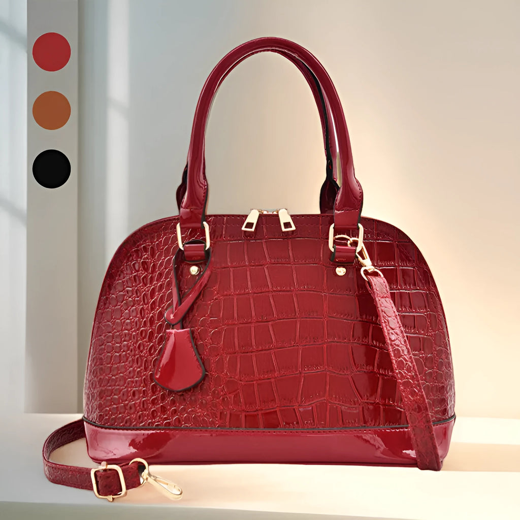 Shiny black PU shoulder bag with crossbody strap showing shell-shaped structure