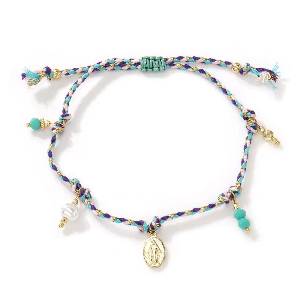 Close-up of a colourful hand-woven adjustable bracelet with an ethnic-style strap tag on a wrist.