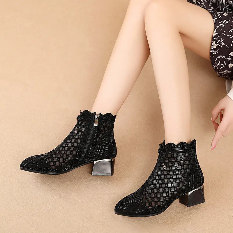 Black women's ankle boots with cutout mesh panels, mid heel, side zipper, and rhinestone sequin details