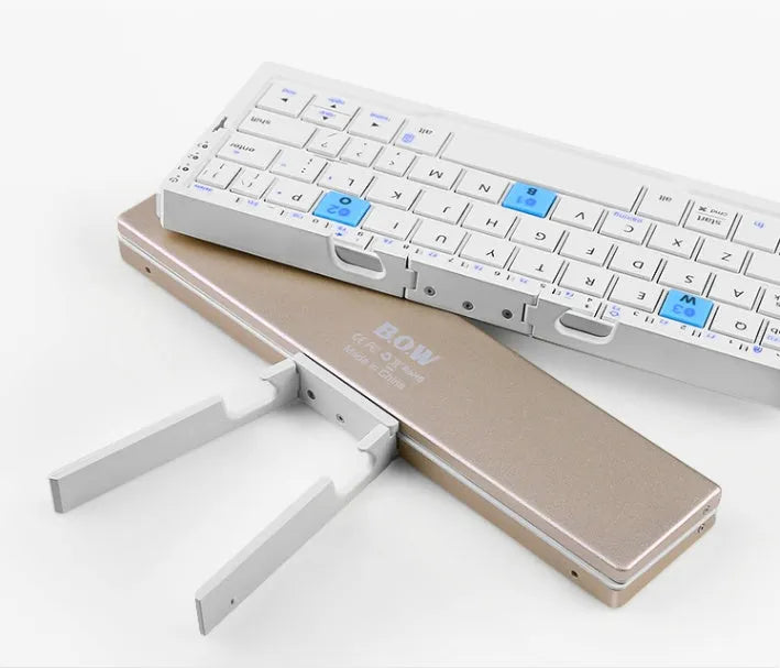Mini folding Bluetooth keyboard with aluminium alloy backboard, hidden stands, and three-device memory, shown open.