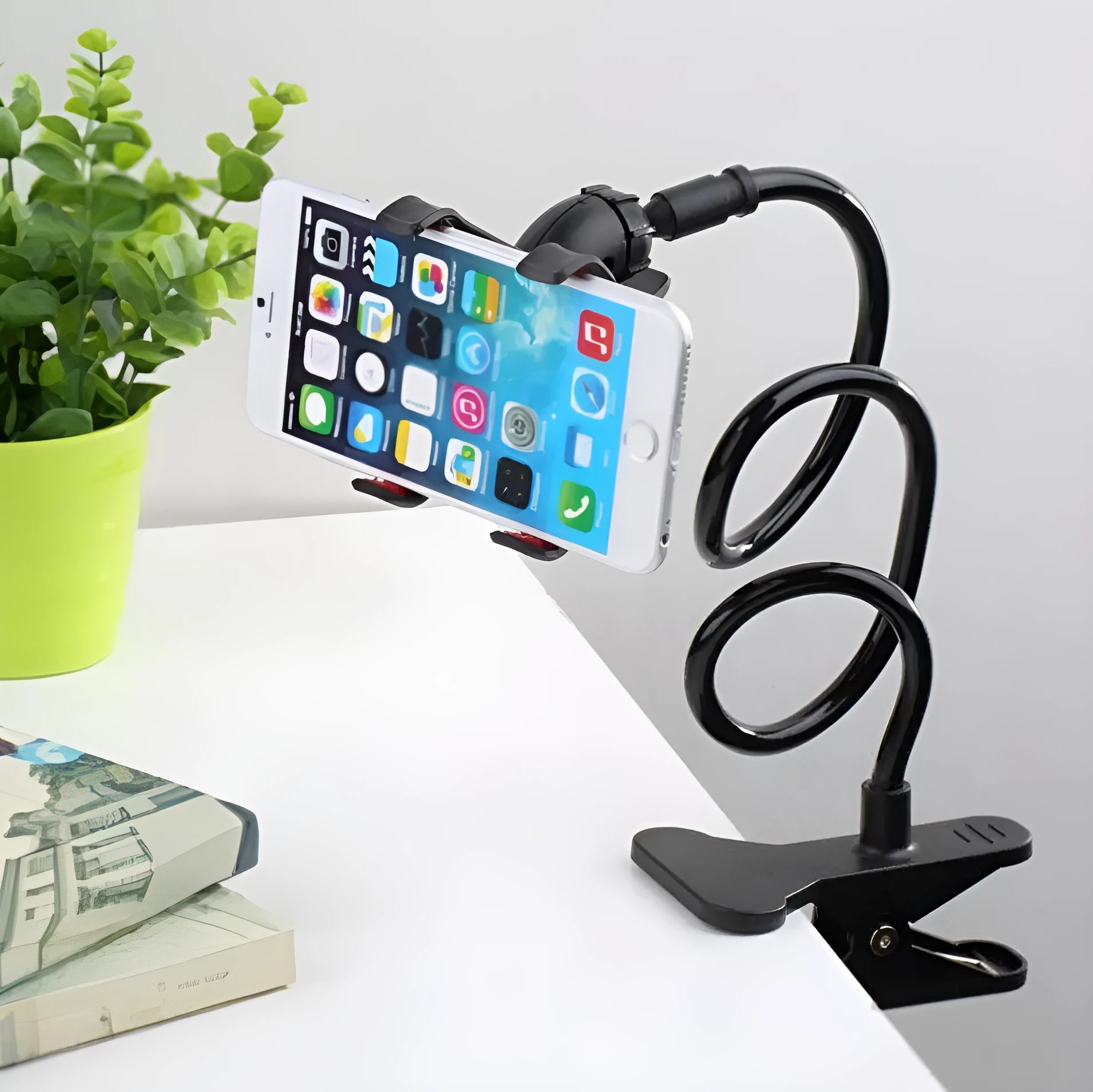 Black flexible long arm phone stand with V-clip holder extended on a desk
