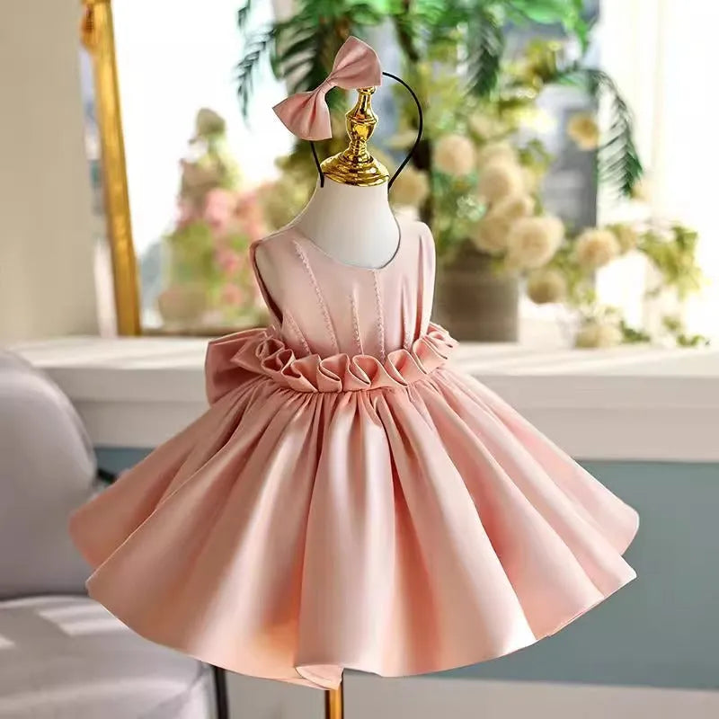 Children's princess dress in flesh pink polyester for piano performance with full skirt and fitted bodice