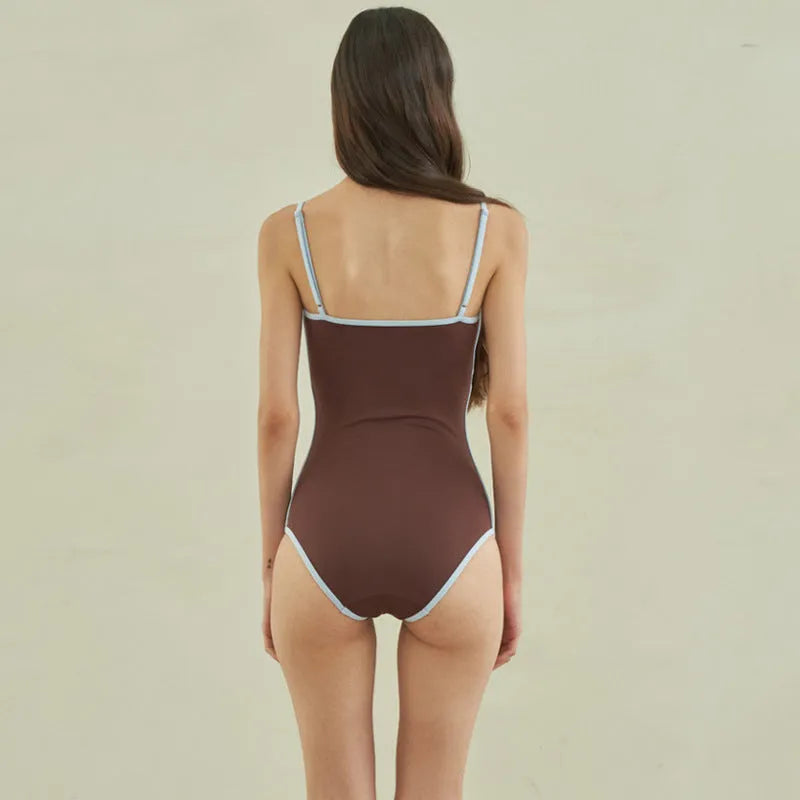 Brown one-piece swimsuit for women on a mannequin, showing the front design.