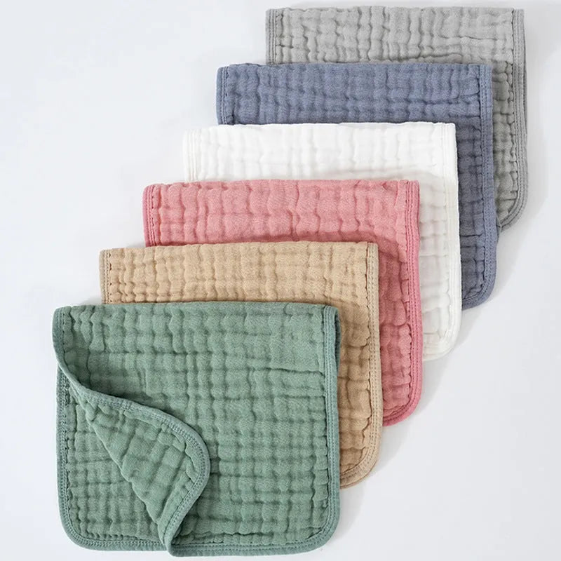 Set of six large muslin burp cloths 25x50cm in assorted colours on white background