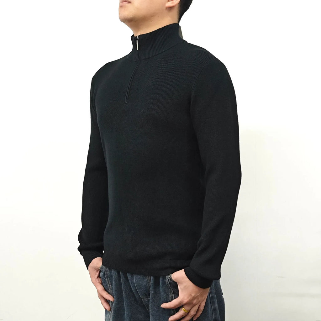 Man wearing a grey half-turtleneck zip-front sweater, a cotton blend pullover for casual wear.