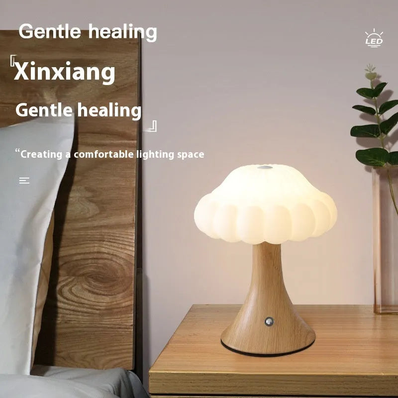 Small decorative mushroom-shaped night lamp in wood grain colour with touch control.