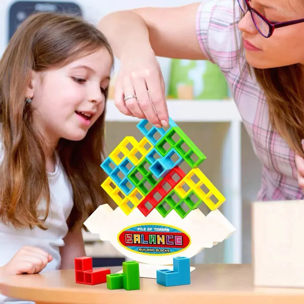 Plastic balance stacking game with coloured blocks on a tilting base, packed in a 26.5 cm box.