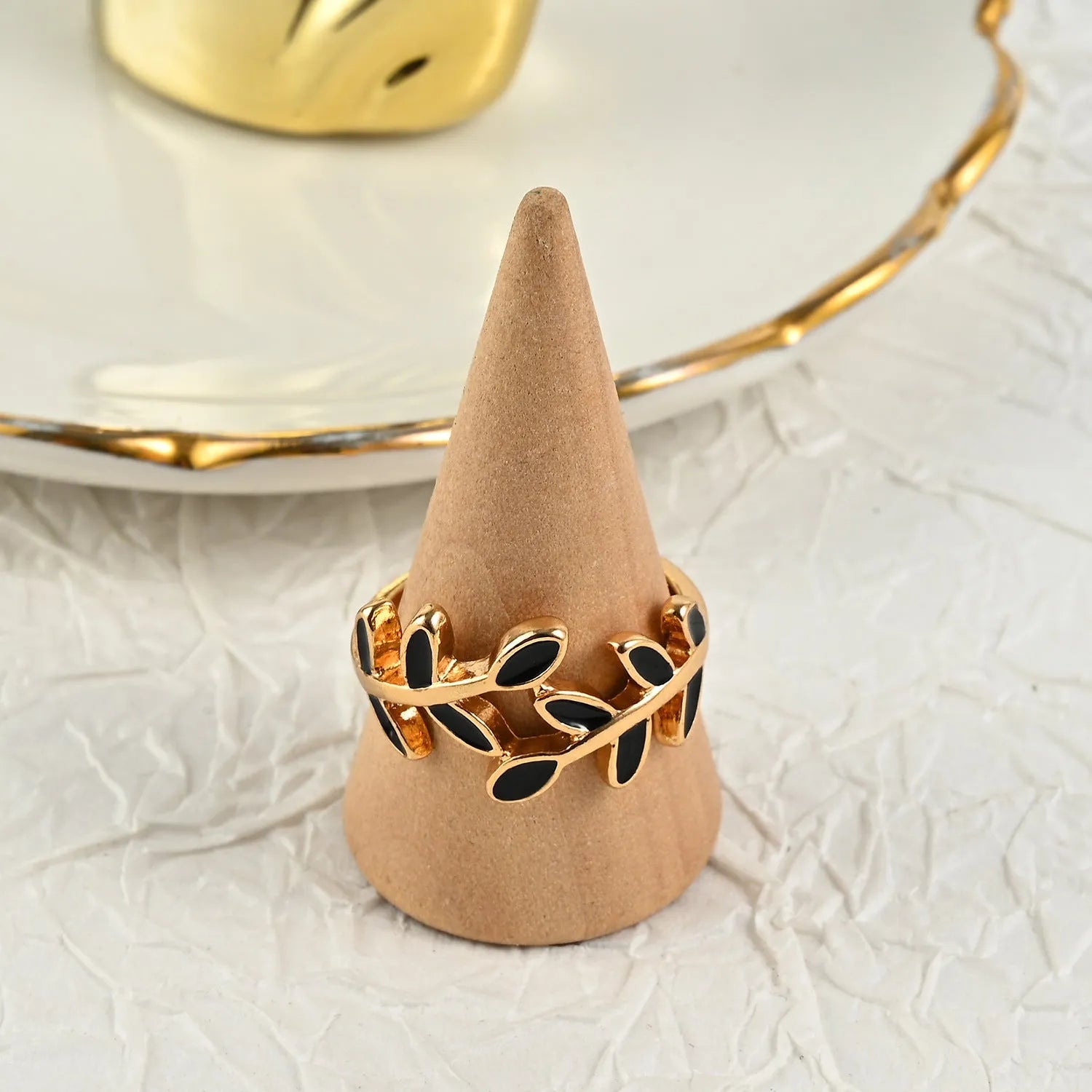 Gold-coloured acrylic ring with a floral shape and leaf geometric design details.