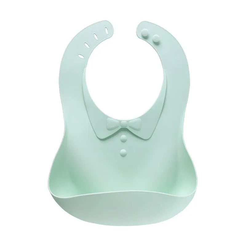 Waterproof soft plastic children bib with cartoon pattern in red, green, and blue colour options