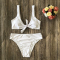 Women's solid colour bikini set showing bra top and briefs in black, pink, red, white, or wine red.