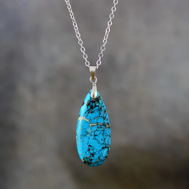 Emperor Stone water drop pendant necklace with genuine jade centre and 18K gold plated setting on a chain.