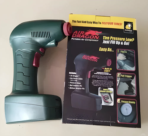 Portable electric car tyre inflator with motor and air pump components on a garage floor.