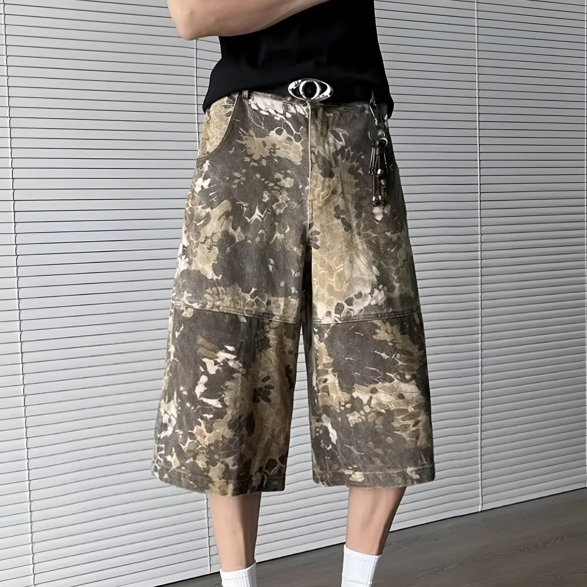 Yellow cotton denim jeans with snake camouflage pattern and cropped leg length.