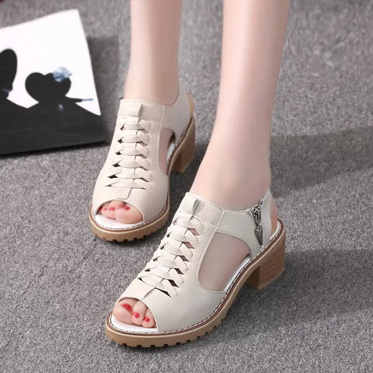 Women's black sandals with side zip and mid heel on a beef tendon sole.