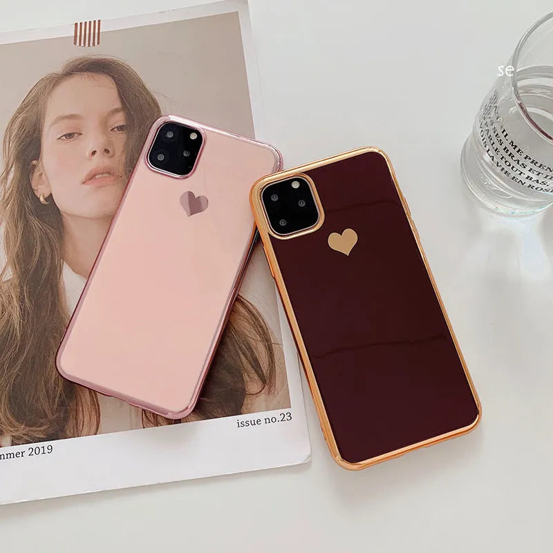 Solid colour TPU back cover case for iPhone on a table, showing blue, claret, pink, and green options.