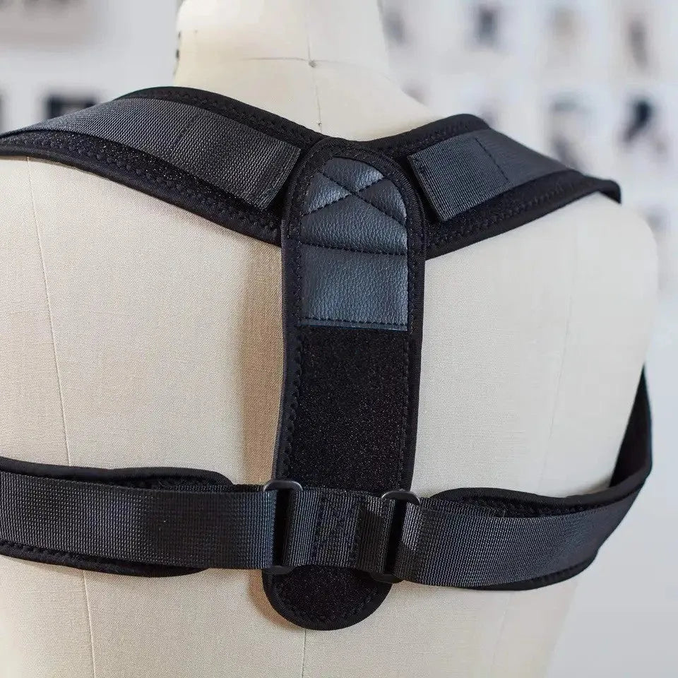 Black adjustable posture correction strap showing breathable construction and adjustable mechanism