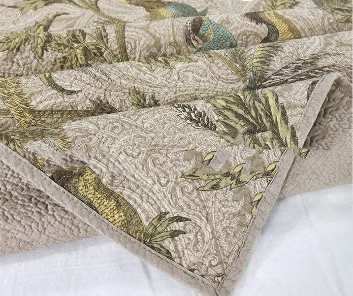Blue American floral and bird pattern quilted cotton bedspread set on a double bed