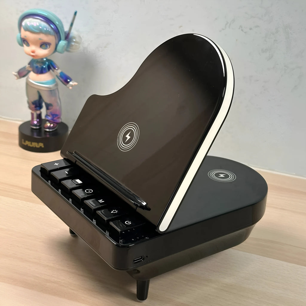 Black multi-function Bluetooth speaker wireless charger and phone holder on a desk