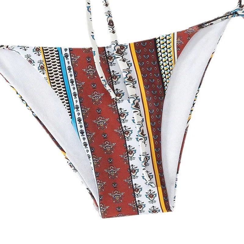 Women's printed lace-up split swimsuit in mixed colours, showing sleeveless one-piece design.