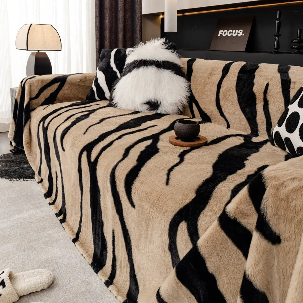 Zebra pattern thickened flannel sofa cover in caramel colour with matching pillowcase on a grey sofa.