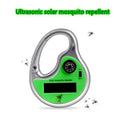 Green portable solar ultrasonic mosquito repellent on grass with sunlight charging