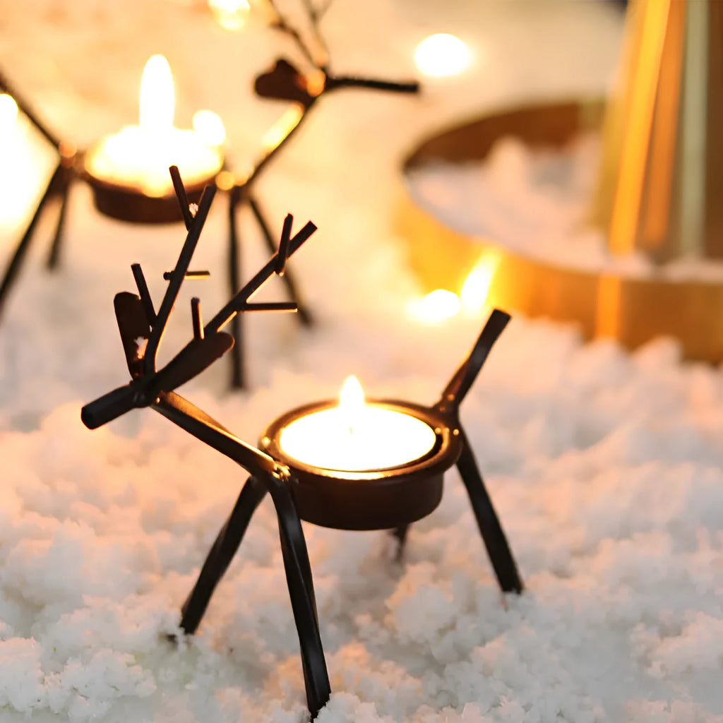 Black iron Christmas candlestick holder with decorative elk bracket design.