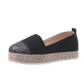 Beige and black women's canvas flat shoes with round toe and slip-on design.