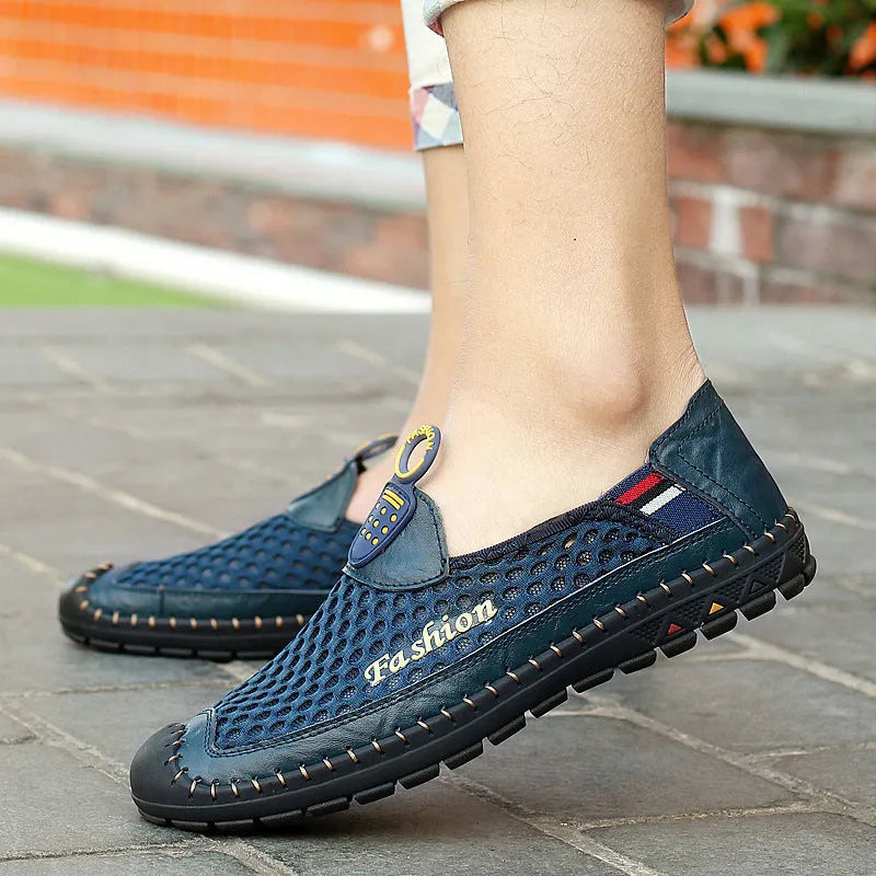 Men's brown mesh casual shoes with round toe and rubber sole on a plain background.