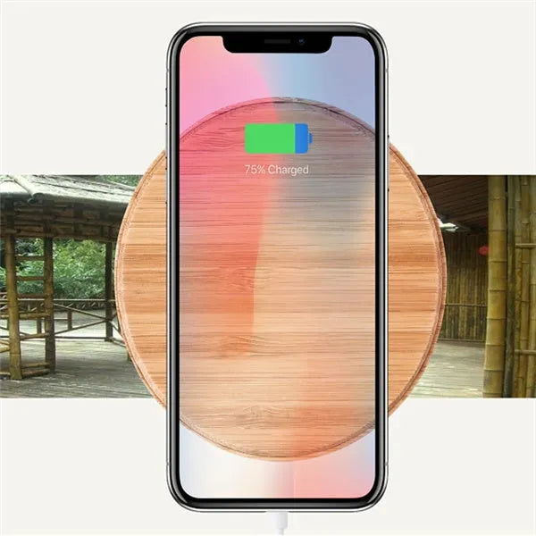 Natural bamboo wireless charger pad on desk with a smartphone placed on it