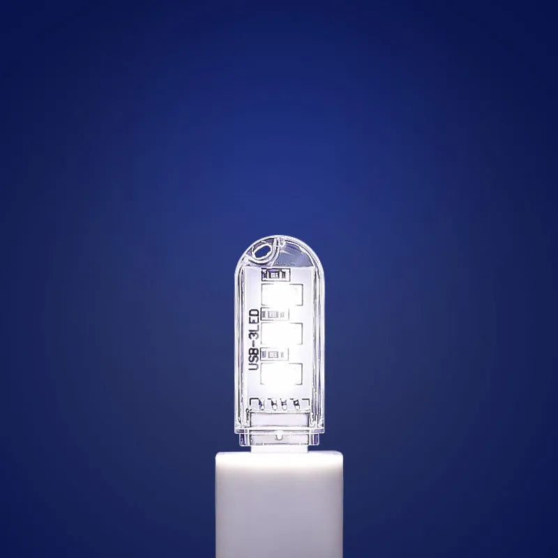 Small white USB-powered LED baby night light showing white and warm light options.