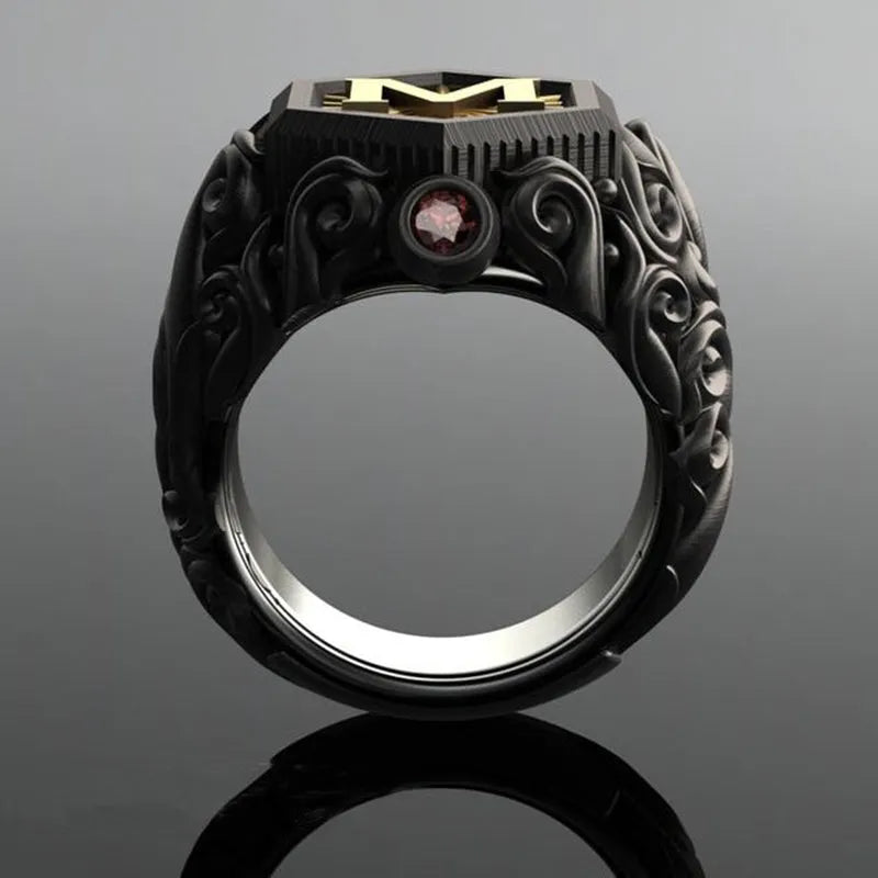 Black alloy decorative ring with carved leaf design on white background